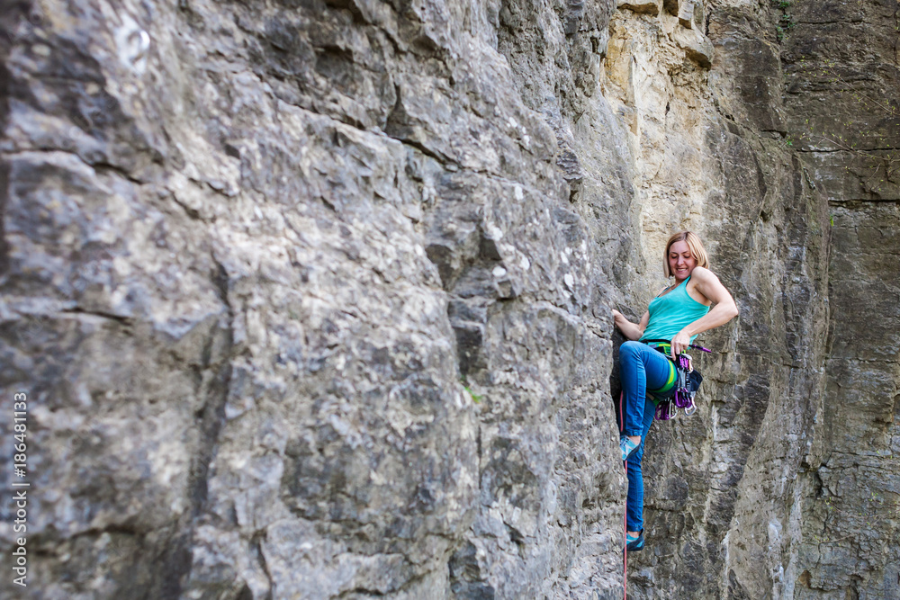 A woman climber on a rock.