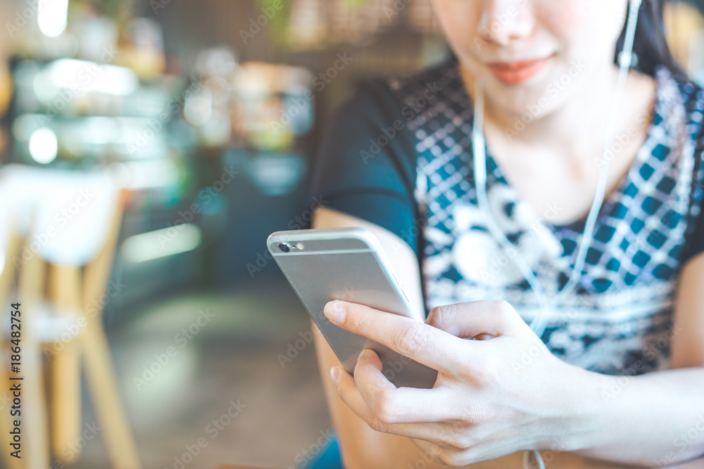 Women hand are listening to music from mobile phones.