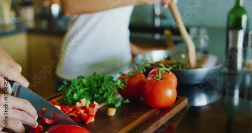 Close up of couple chopping fresh vegetables cooking in the kitchen