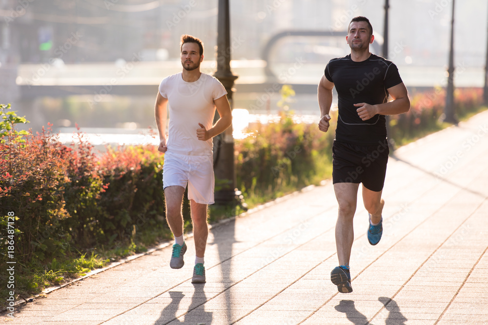Fototapeta premium group of young people jogging in the city