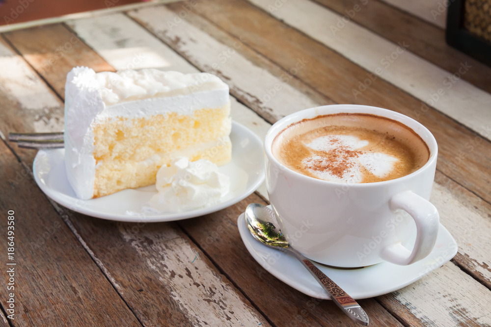 Coffee and cake are placed on a wooden table. Coffee and cake are placed on a wooden table.
