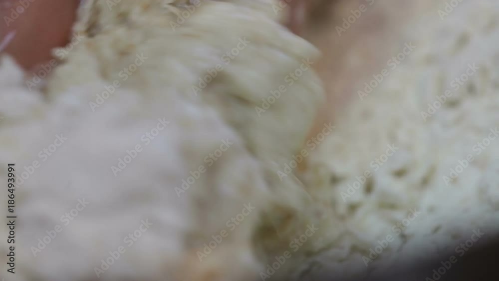 Mani di un uomo che impastano la farina con acqua per fare la pizza italiana tipica in casa.