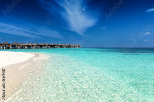 Strand auf den Malediven mit t  rkisem Meer  feinem Sand und tiefblauem Himmel