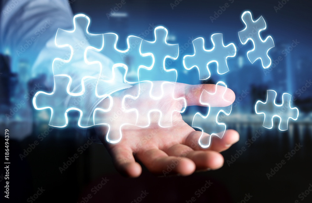Businessman holding hand-drawn puzzle pieces Businessman holding hand-drawn puzzle pieces