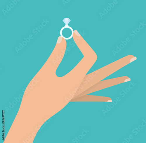 Woman's hand holding diamond ring
