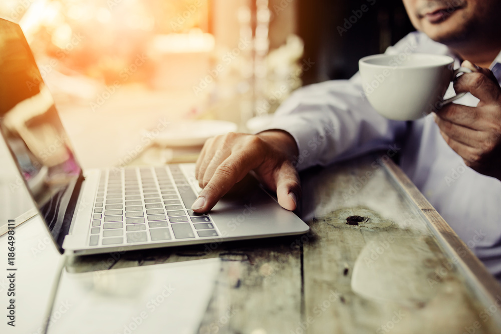 Fototapeta premium businessman use smartphone and laptop on wwoden desk business ideas concept