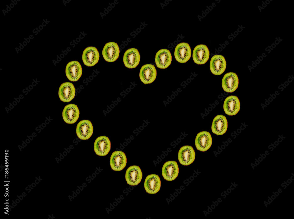 Heart made from sliced fresh kiwi. Love concept. Fresh sliced kiwi background. Heart made from sliced fresh kiwi. Love concept. Fresh sliced kiwi background.