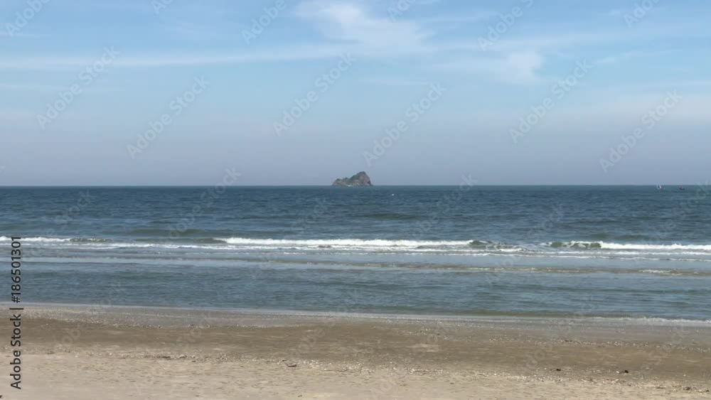 Wave gently splashing on the shore early morning in sunrise Wave gently splashing on the shore early morning in sunrise