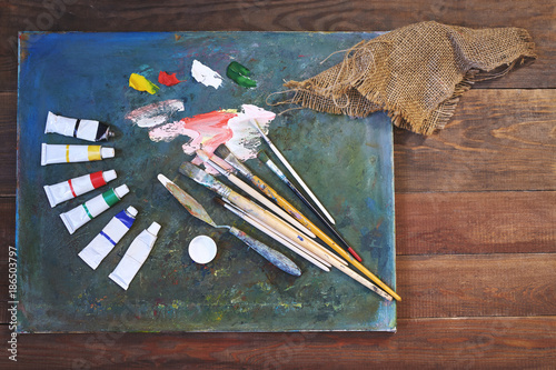 oil paints and paint brushes on a palette photo