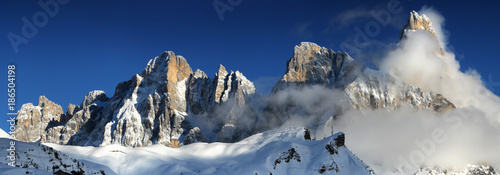 Scenic winter Landscape of Pale di San Martino group with the famous Cimon della Pala wrapped in clouds. Seen from Passo Rolle near San Martino di Castrozza, Val di iemme. Trentino Alto-Adige, Italy.