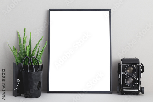 mock up blank photo frame with houseplant on shelf. photo