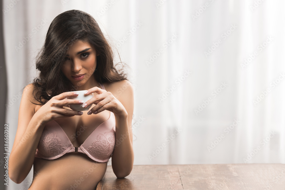 beautiful sexy woman in bra drinking coffee and looking at camera Stock  Photo | Adobe Stock