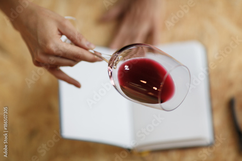 Attractive woman check red wine in white paper background