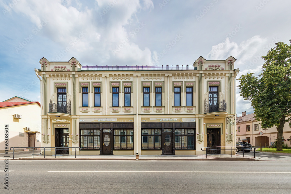 old beautiful with restored facade building in sunny day near the road. Urban development of the 19th century