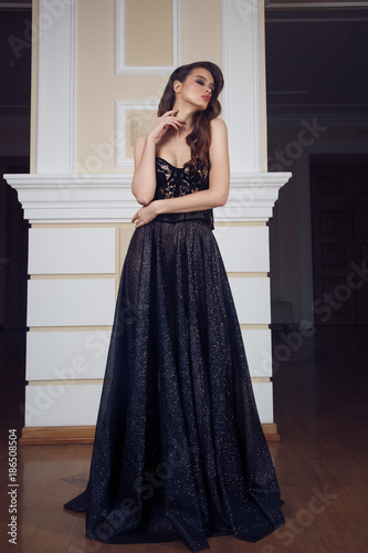 Fototapeta Full lenght portrait of gorgeous woman in the long black dress