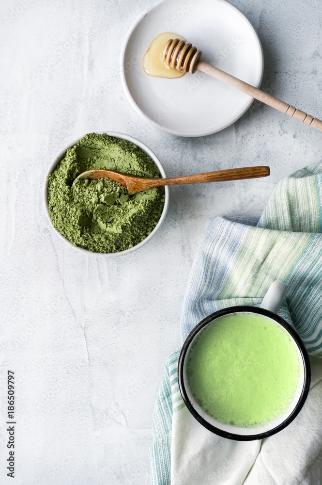 Cooking creamy matcha latte. Top view. Traditional japanese green tea powder with hot milk in mug. Cooking creamy matcha latte. Top view. Traditional japanese green tea powder with hot milk in mug.