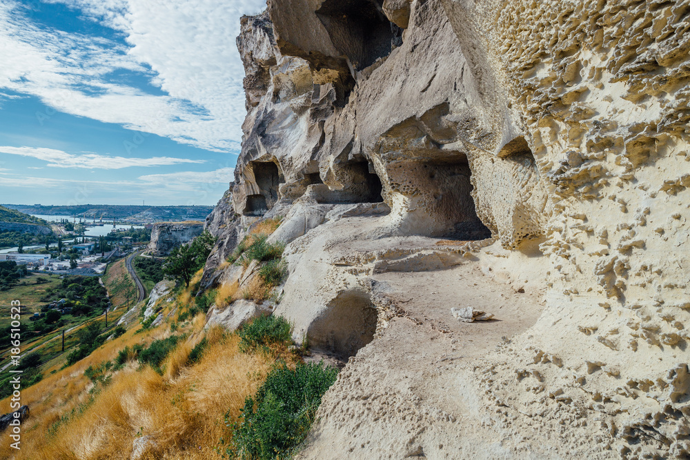 Ruined monastery carved in rock monastic caves. Zagaytanskaya rock, Inkerman, Crimea