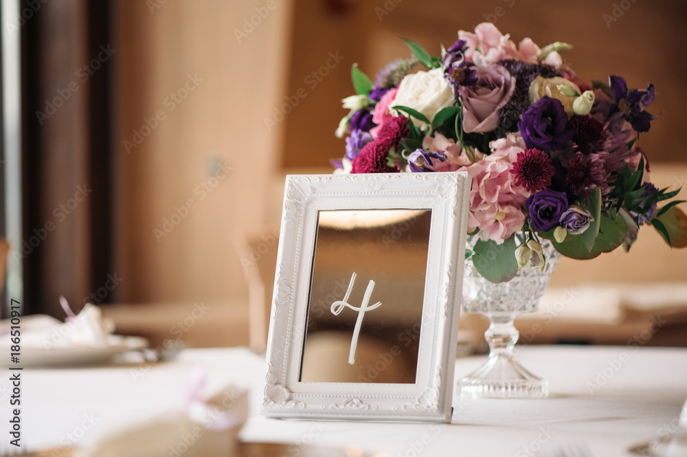 Obraz premium Wedding table with flowers and sign number