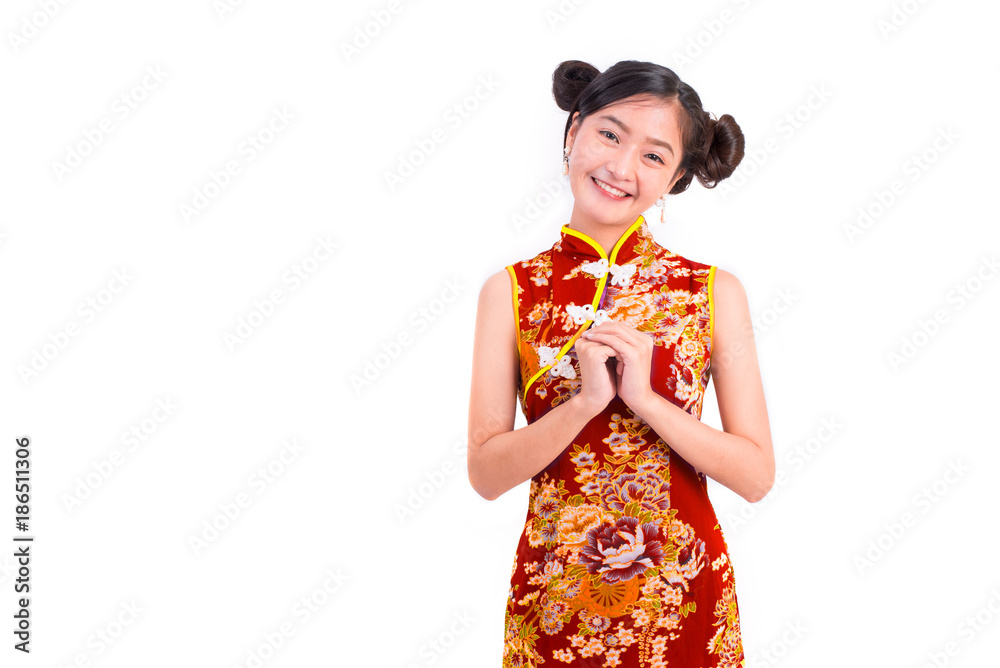 Young Asian beauty woman wearing cheongsam and blessing or greeting gesture in Chinese new year festival event on isolated white background. Holiday and Lifestyle concept. Qipao dress wearing Young Asian beauty woman wearing cheongsam and blessing or greeting gesture in Chinese new year festival event on isolated white background. Holiday and Lifestyle concept. Qipao dress wearing