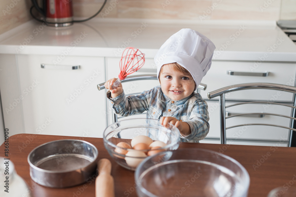 adorable little kid in chef hat with whisk and eggs adorable little kid in chef hat with whisk and eggs