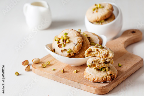 Butter cookies with pistachios on wooden board