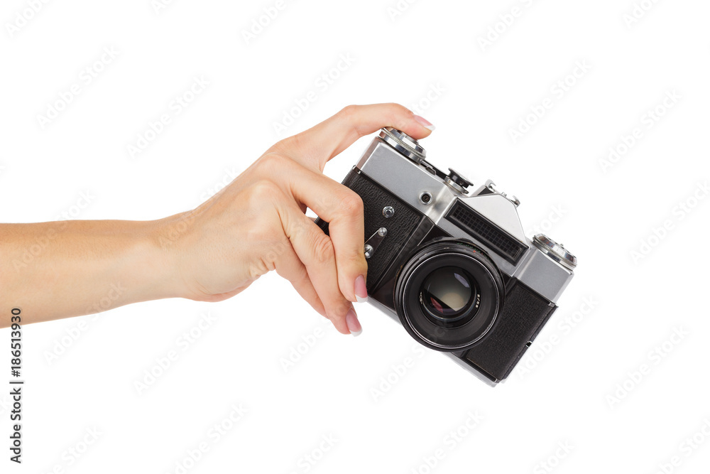 Fototapeta premium Hand holds an old photo camera, isolated