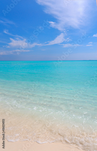 Peaceful white sandy beach with blue ocean lagoon
