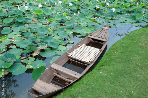 Traditional Vietnamese boat in a lotus pond in the Mekong delta
