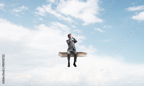 Wallpaper Mural Young man on book in blue sky do not want to see anything Torontodigital.ca