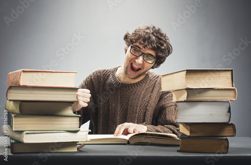 Excited man reading a book, studying