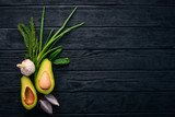 Avocado, onion and dill on a wooden background. Top view. Free space for your text.