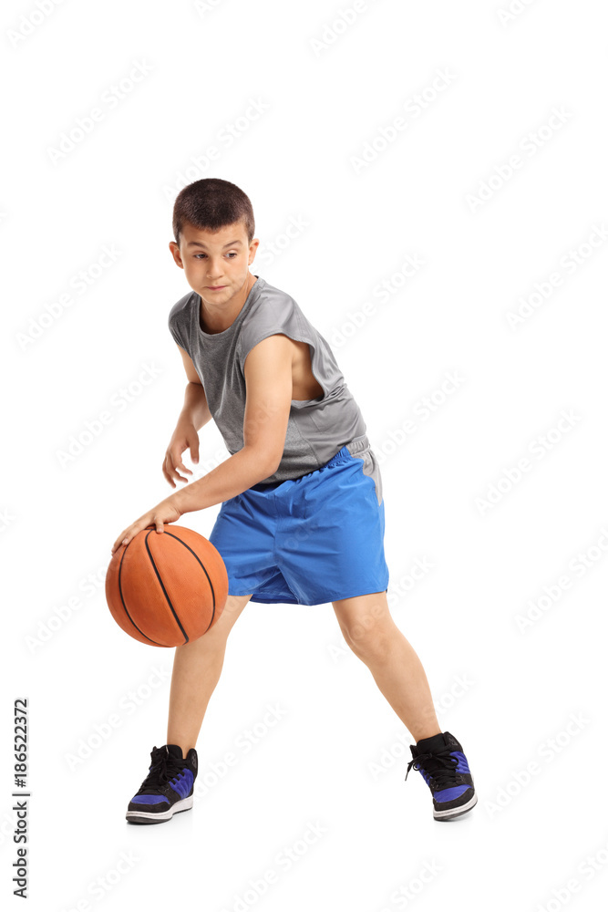 Naklejka premium Boy dribbling with a basketball