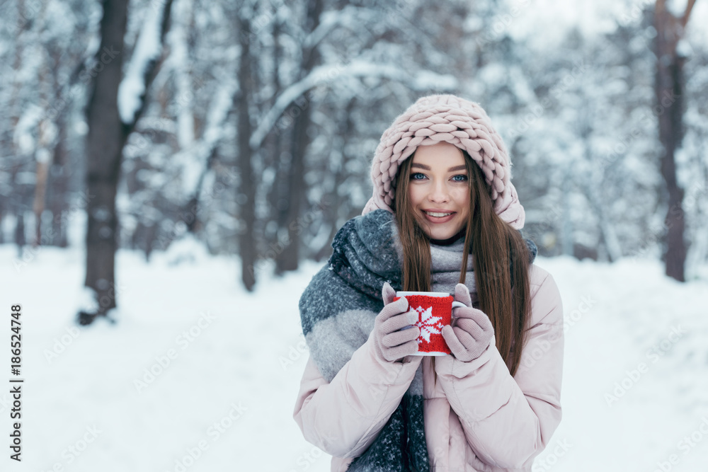portrait of beautiful young woman with cup of hot coffee in hands in snowy park portrait of beautiful young woman with cup of hot coffee in hands in snowy park
