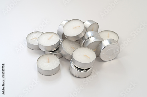 Quadro su tela A large group of tea light candles atop a white plastic background