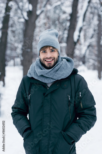 portrait of handsome smiling man looking at camera in winter park © LIGHTFIELD STUDIOS