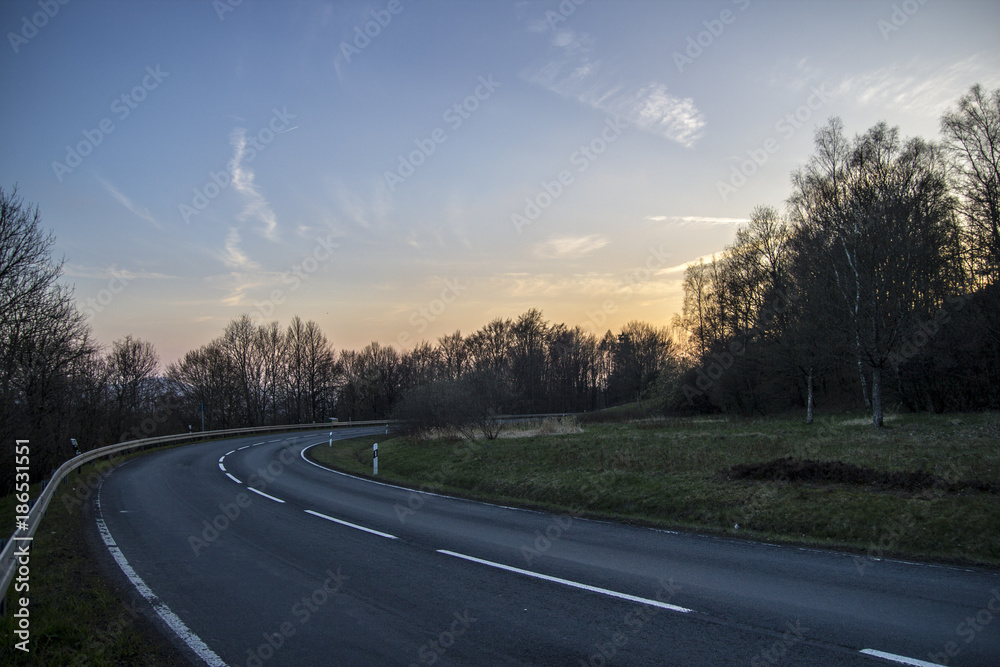 asphalt road to sunset