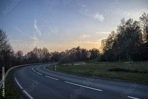 asphalt road to sunset