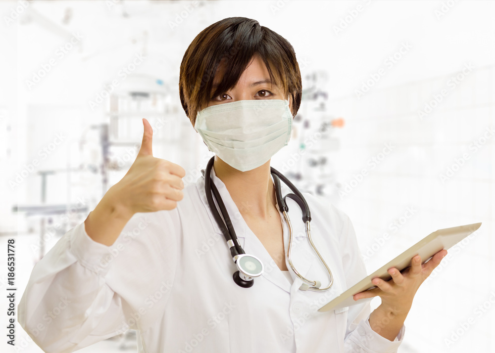 Asian female doctor with tablet computer, thumbs-up in clinic lab Asian female doctor with tablet computer, thumbs-up in clinic lab