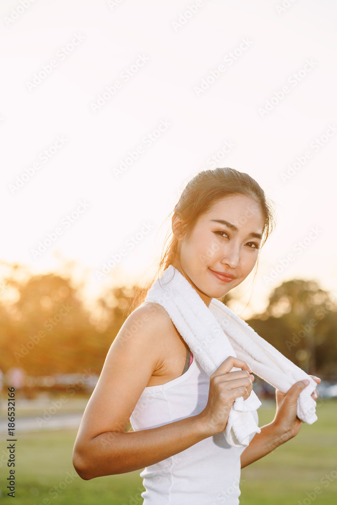 A women is exercising and relaxing at the park. A women is exercising and relaxing at the park.
