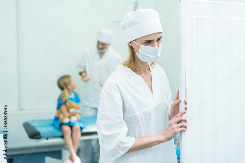 doctors preparing kid for surgery in operating room doctors preparing kid for surgery in operating room