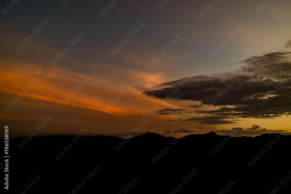 The ridge is a black silhouette. Sunset time. Use as background. The ridge is a black silhouette. Sunset time. Use as background.