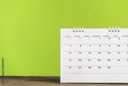 close up of calendar on the table with green background, planning for business meeting or travel planning concept