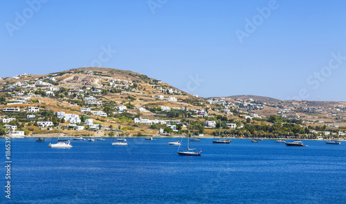 Greece. Cyclades. Paros island. Picturesque white houses near Parikia town. Yachts in the sea