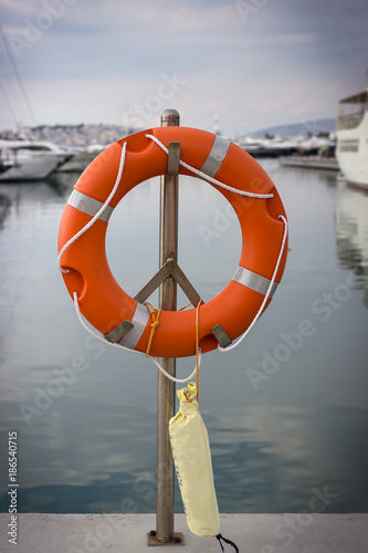 Bright orange lifebuoy on the sea water background. Athens, Greece