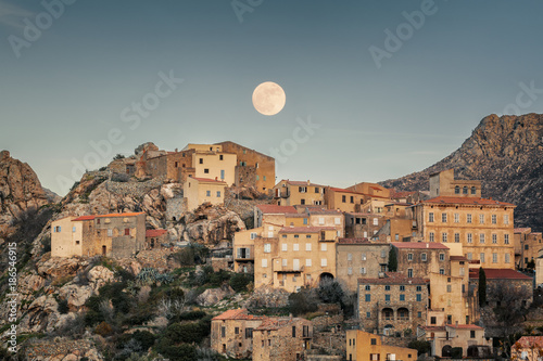 Full moon over Balagne village of Speloncato in Corsica photo