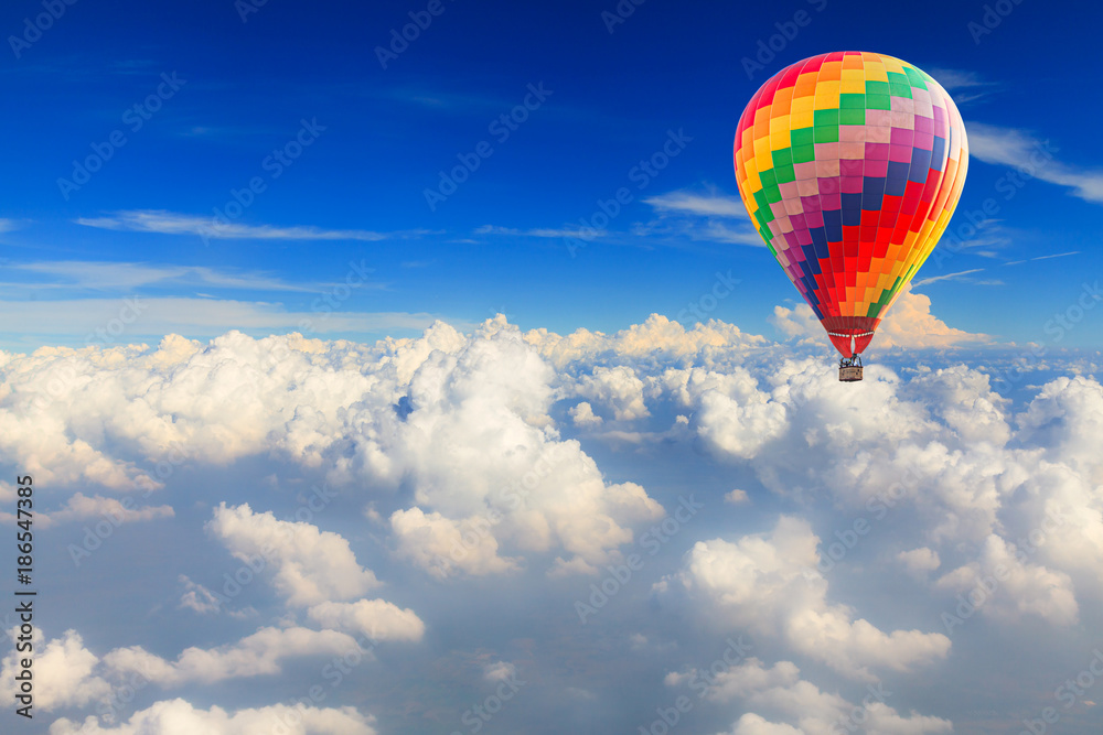 Fototapeta premium Hot air balloon over the white cloud on blue sky
