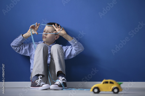 Fototapeta Naklejka Na Ścianę i Meble -  Autistic child playing blue gum