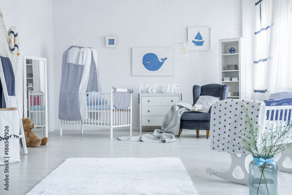 White crib with striped veil