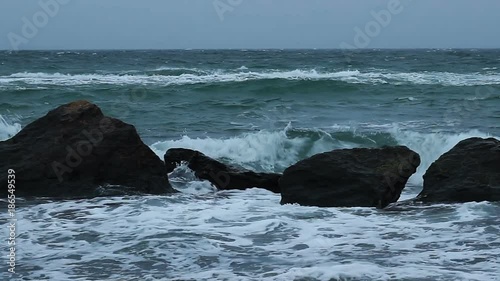 Sea waves breaking at seawall in winter storm. photo