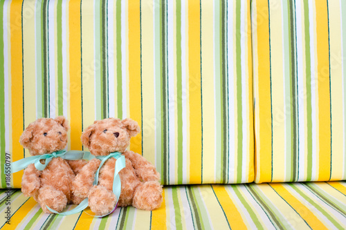 Teddy bears sitting on colourful background